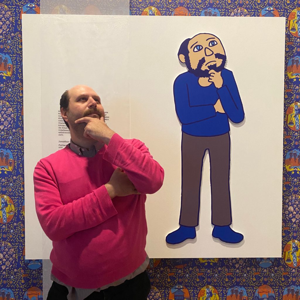 portrait of Jonathan Rotsztain in front of his installation "Patterns" at the Jewish Museum Vienna
